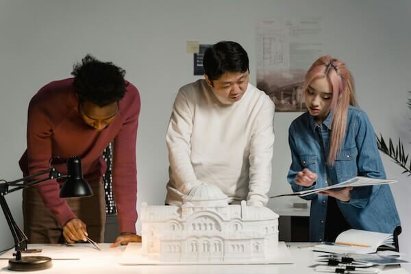 Group of designers working together to figure out which web design hack to use.