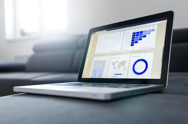 Laptop displaying analytics dashboard with graphs and data, illustrating strategies for improving content visibility in digital marketing.